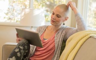 photo of cancer patient at home with computer