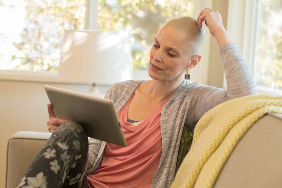 photo of cancer patient at home with computer