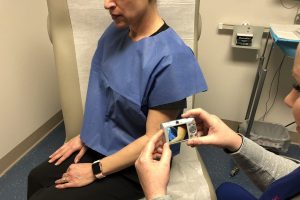 Kaiser Permanente Teledermatology Finds More Skin Cancers with Fewer Dermatology Visits photo of doctor evaluating patient through technology