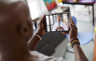 COVID-19 Pandemic Brings Telehealth Center Stage for Oncologists and Their Patients photo of patient on telehealth call with physician