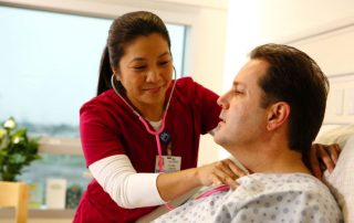 photo of patient and medical professional giving exam