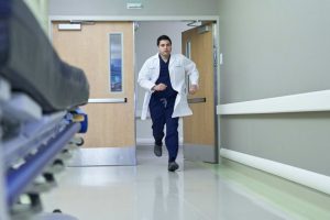 photo of doctor running down hospital corridor