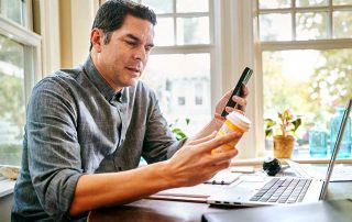 photo of patient reading medication label on telehealth call