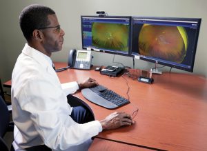 Dr. Jean-François reviews a patient’s retinal scan to evaluate the progression of diabetic retinopathy.