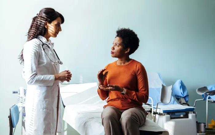 patient seated, talking with physician