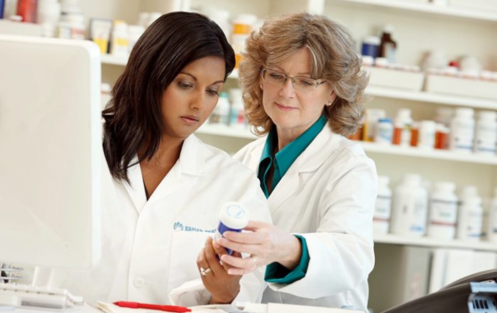 Two Kaiser Permanente pharmacists reviewing medication